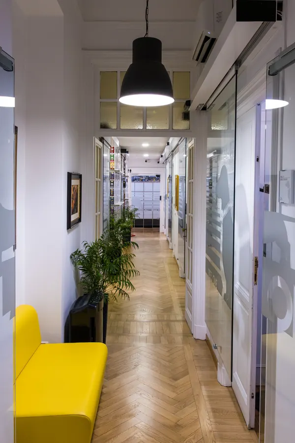 Il corridoio dello studio, con la panca gialla e il parquet a spina